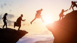 Business people jumping over a gap