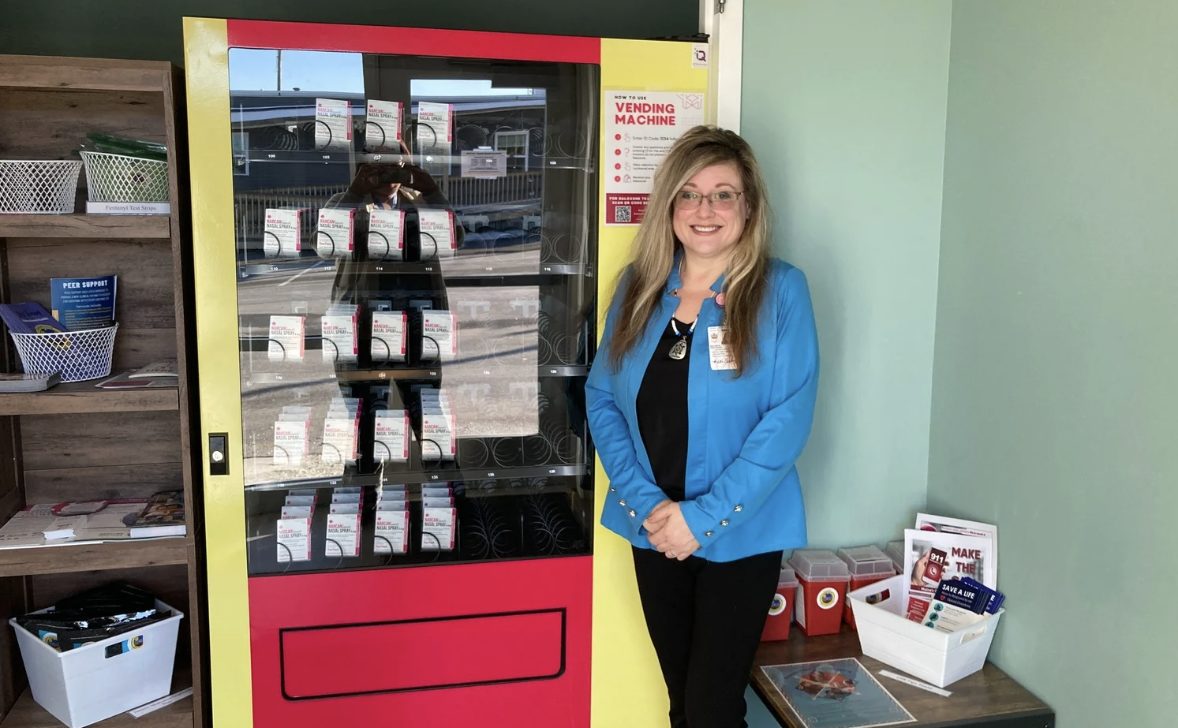 Woman standing next ot vending machine